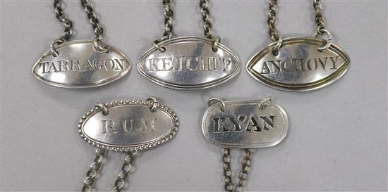 Five George III silver sauce labels;